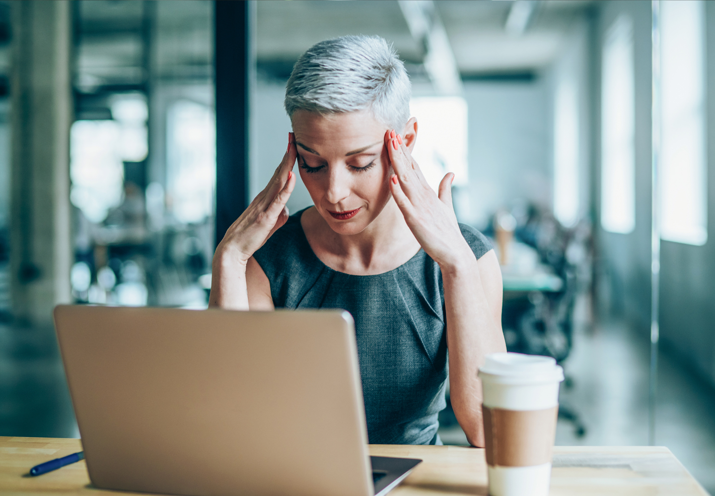 Stressed businesswoman with headache in the office