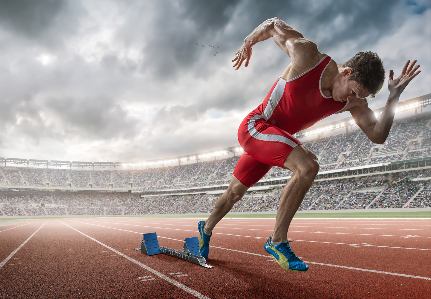 Athlete sprinting from starting blocks